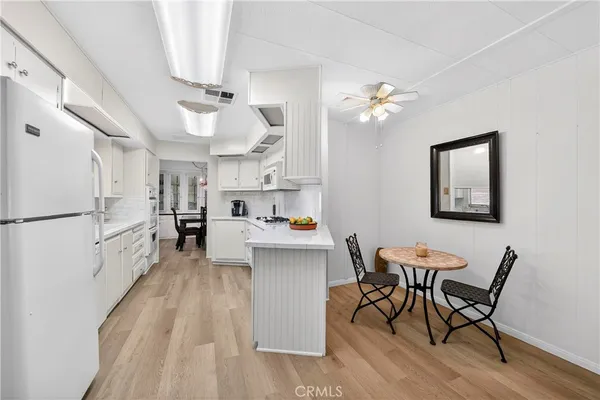 a kitchen view with stainless steel appliances a stove a chandelier and a refrigerator