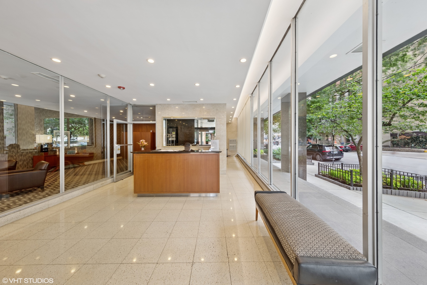 850 North Dewitt Place, Unit 18G Chicago, IL 60611 - Photo 2 of 23 a living room with stainless steel appliances kitchen island granite countertop a refrigerator a sink a dining table and chairs with wooden floor
