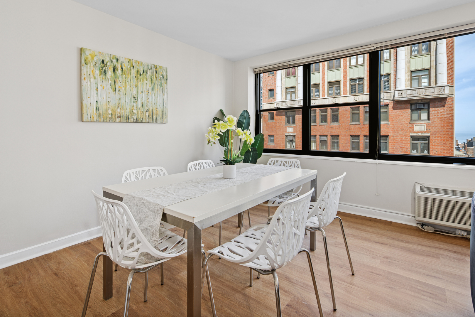 850 North Dewitt Place, Unit 18G Chicago, IL 60611 - Photo 6 of 23 a view of a dining room with furniture window and wooden floor