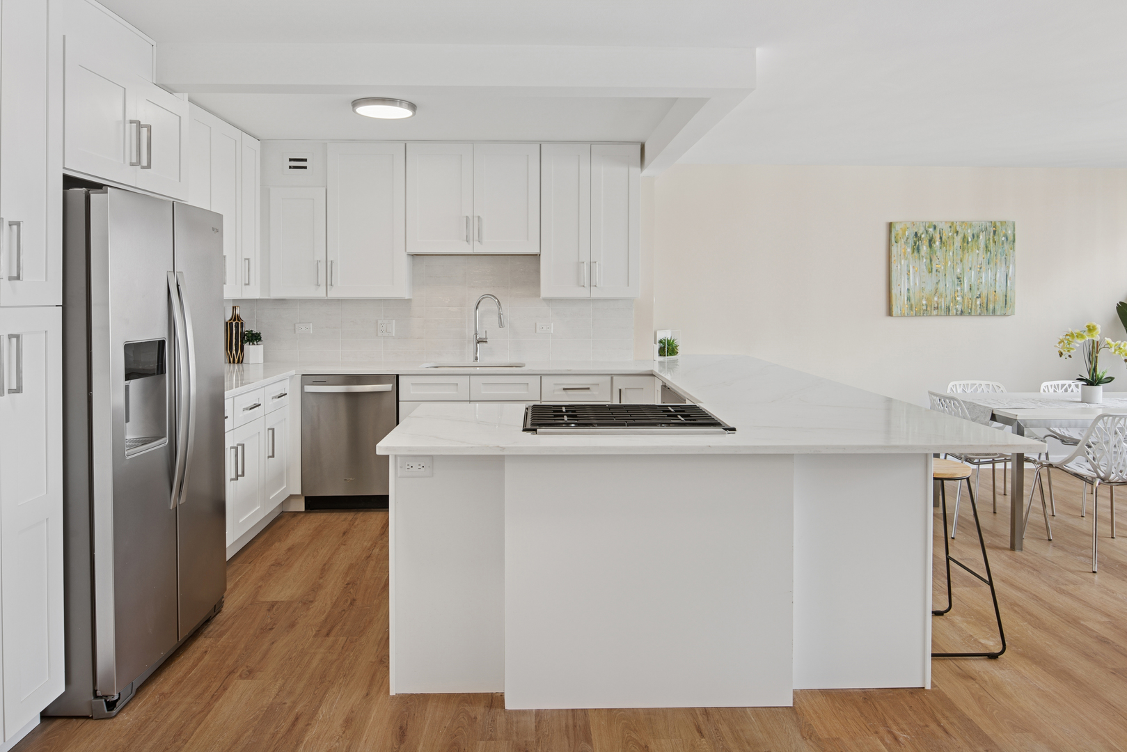 850 North Dewitt Place, Unit 18G Chicago, IL 60611 - Photo 8 of 23 a kitchen with a sink a refrigerator a stove and white cabinets with wooden floor