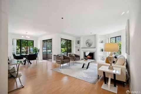 a living room with fireplace furniture and a wooden floor