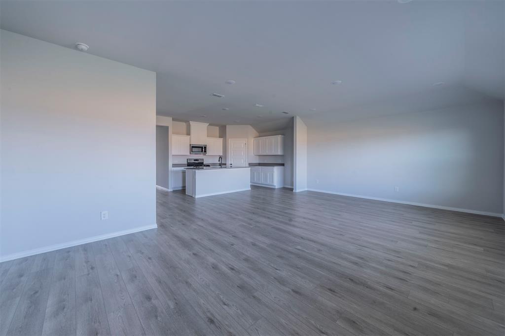 516 Ridgewood Drive Van Alstyne, TX 75495 - Photo 5 of 25 a view of empty room with wooden floor and window