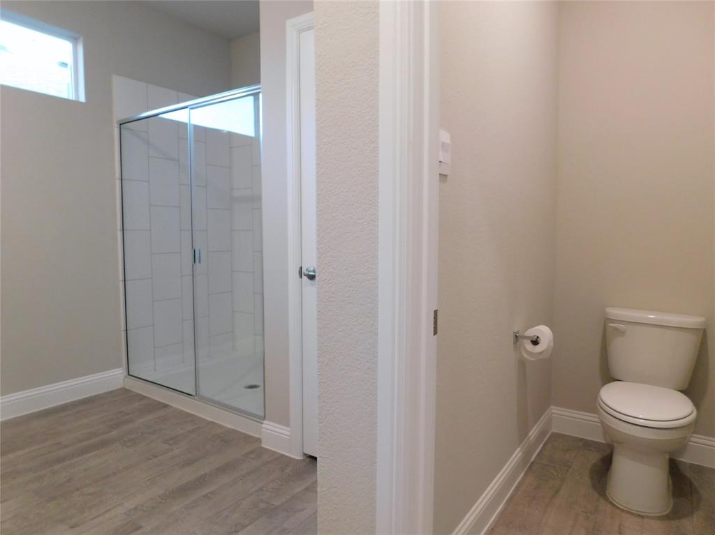 1708 Buzzard Road Denton, TX 76205 - Photo 13 of 28 a bathroom with a toilet and a shower
