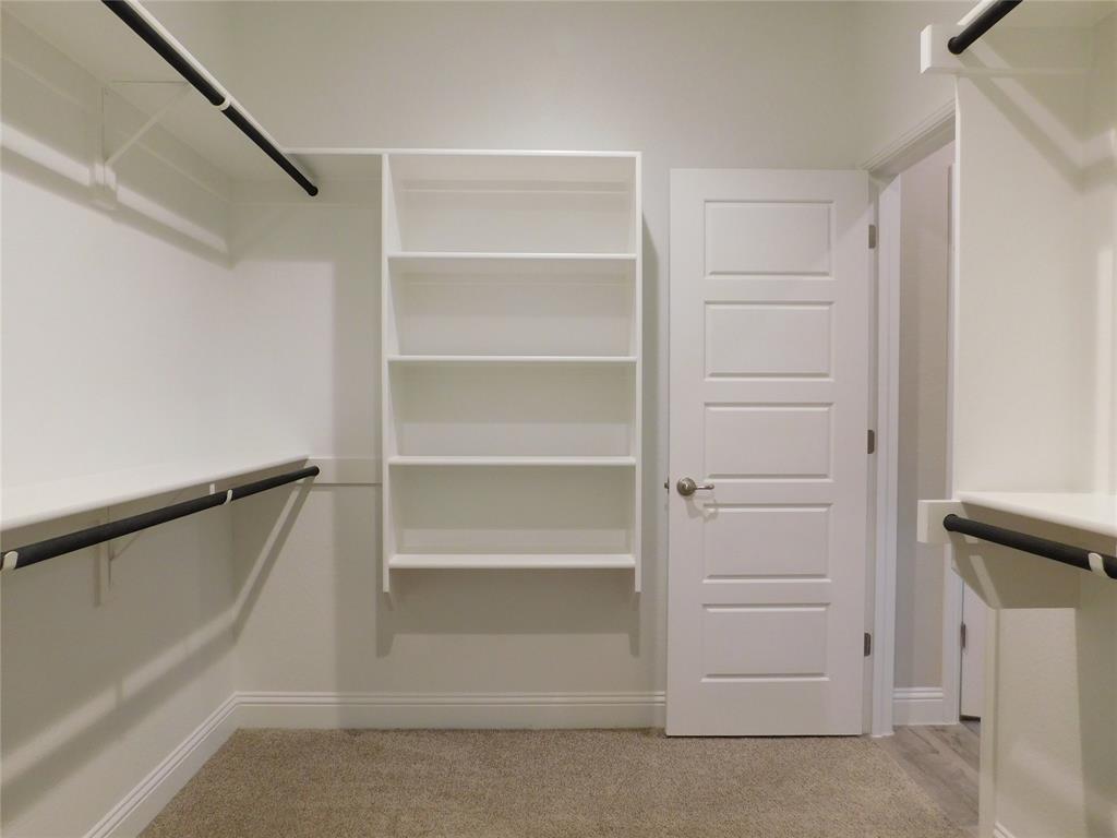 1708 Buzzard Road Denton, TX 76205 - Photo 14 of 28 a view of walk in closet with empty racks