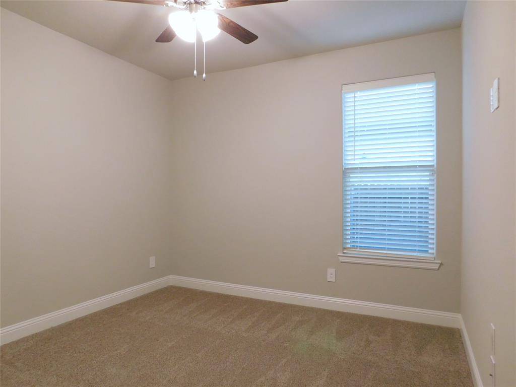 1708 Buzzard Road Denton, TX 76205 - Photo 18 of 28 an empty room with a window and a fan