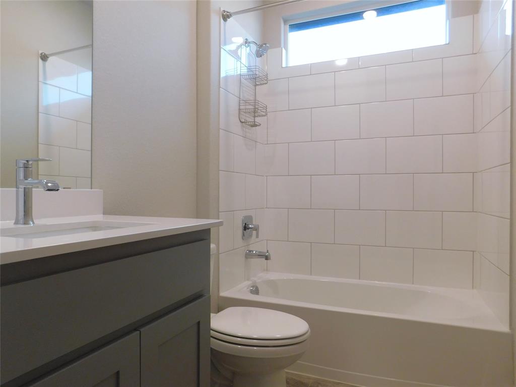 1708 Buzzard Road Denton, TX 76205 - Photo 22 of 28 a bathroom with a sink a toilet and shower