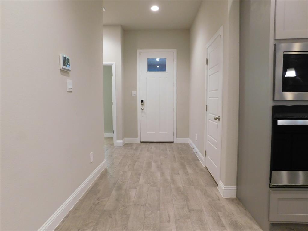 1708 Buzzard Road Denton, TX 76205 - Photo 3 of 28 a view of a hallway with wooden floor and a bathroom