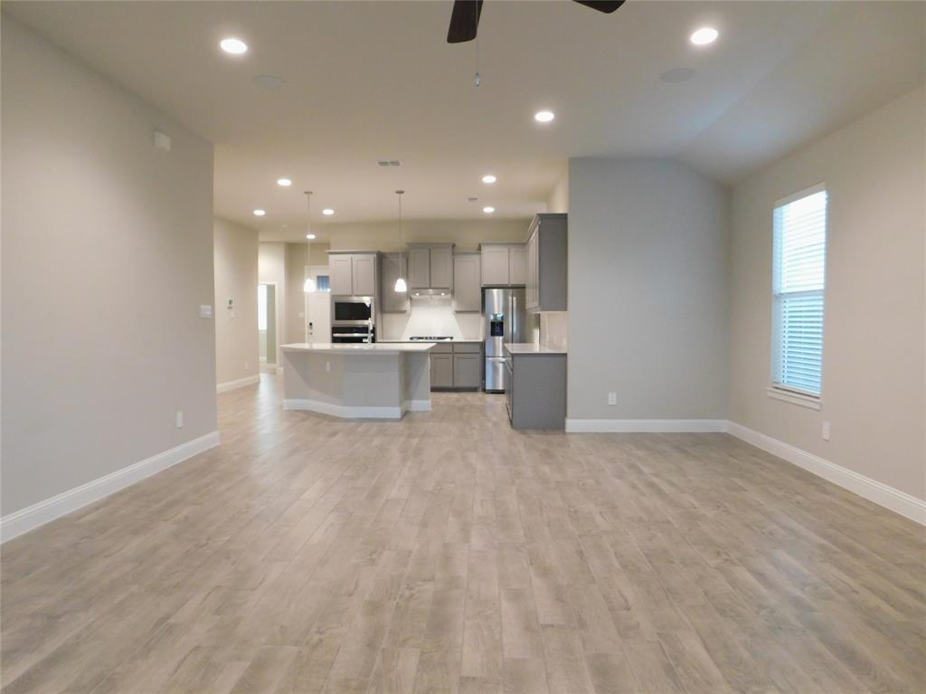 1708 Buzzard Road Denton, TX 76205 - Photo 4 of 28 a view of a kitchen with a sink and microwave