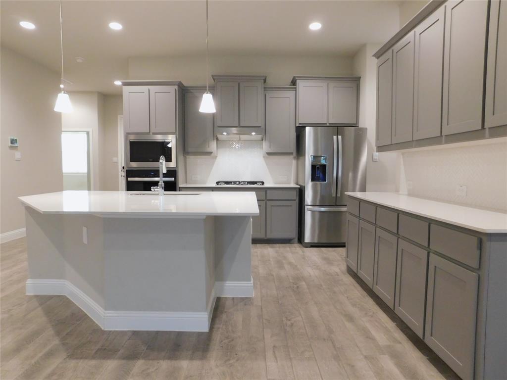 1708 Buzzard Road Denton, TX 76205 - Photo 5 of 28 a kitchen with stainless steel appliances a sink a stove a refrigerator and cabinets