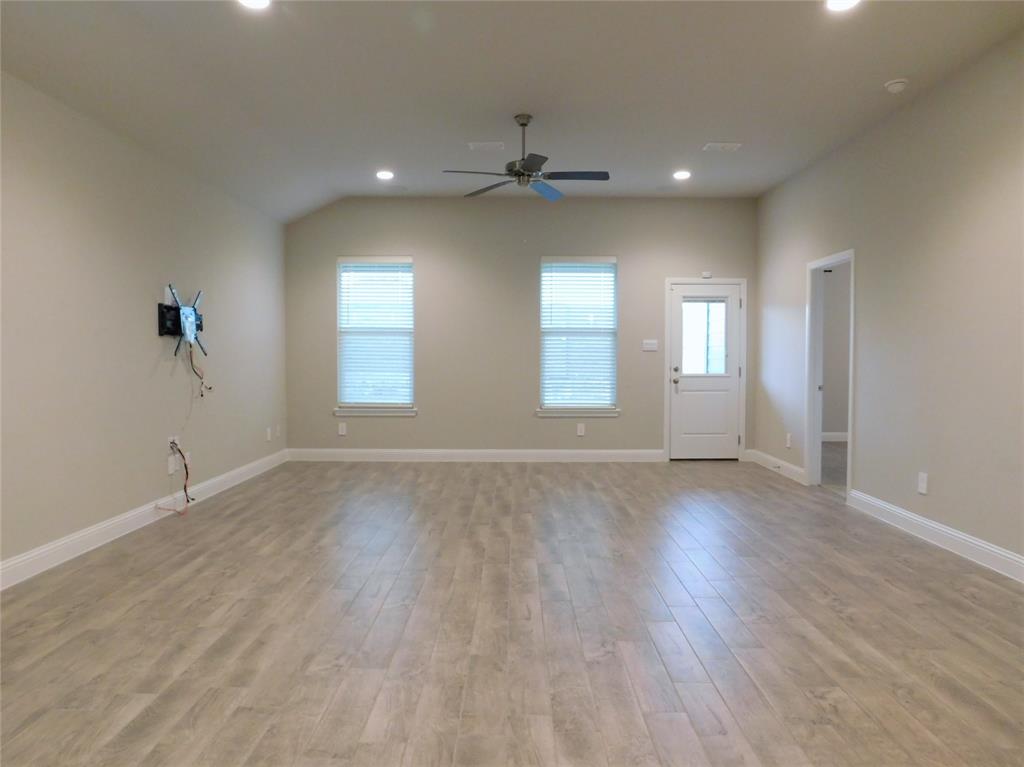 1708 Buzzard Road Denton, TX 76205 - Photo 9 of 28 an empty room with wooden floor and windows