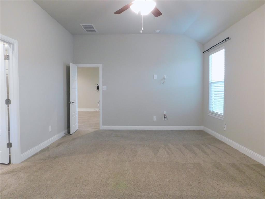 1708 Buzzard Road Denton, TX 76205 - Photo 10 of 28 an empty room with chandelier fan and windows