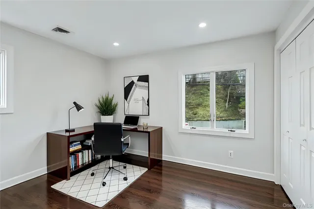 a living room with furniture flat screen tv and a window