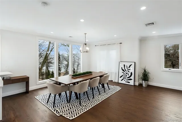 a kitchen with kitchen island stainless steel appliances a stove a sink a refrigerator and cabinets