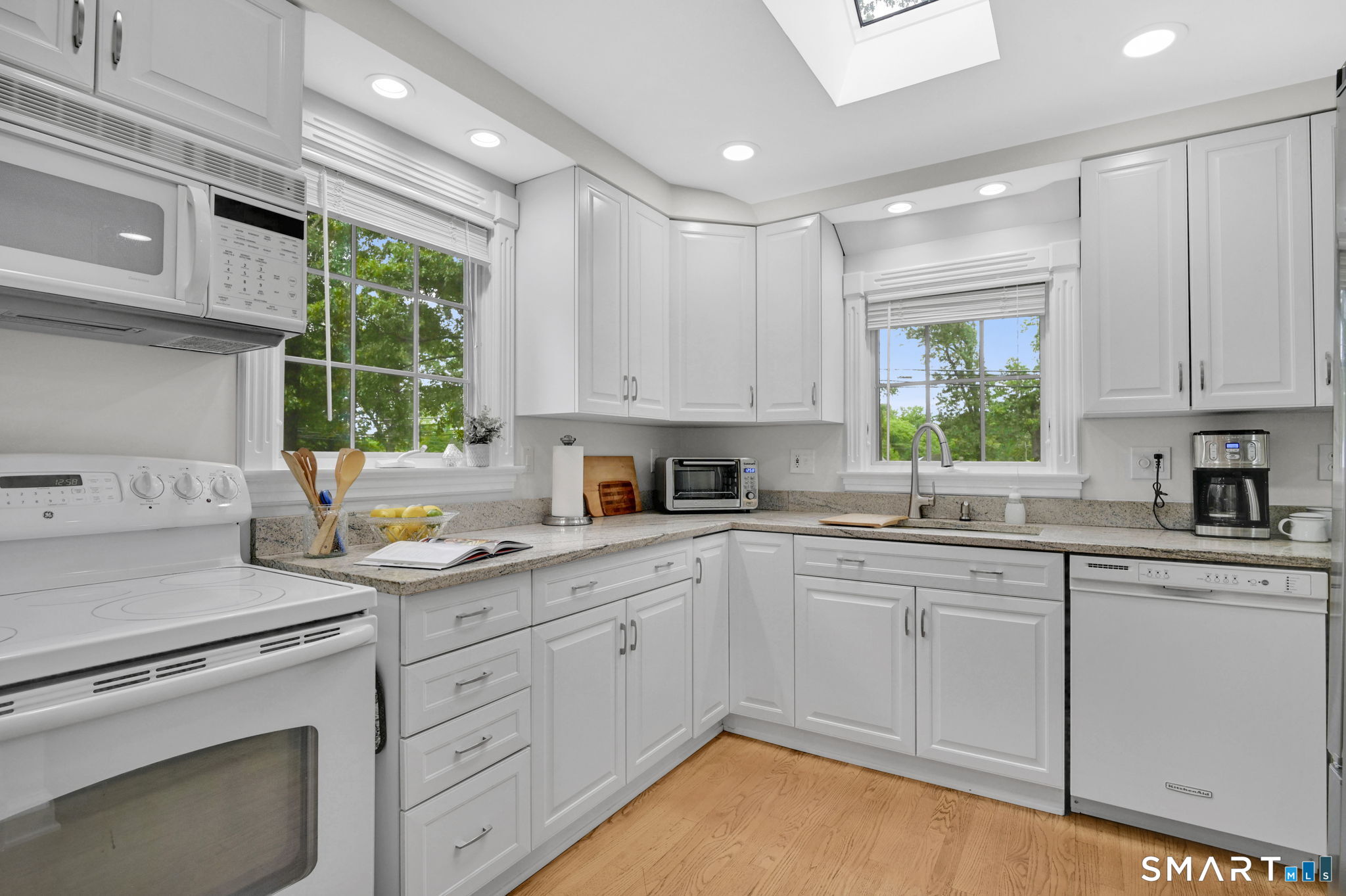 35 S Road Enfield, CT 06082 - Photo 3 of 40 Kitchen with granite counters, skylight, farm sink, hardwood floors.