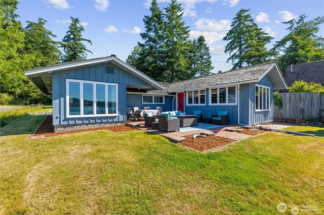 a view of a house with swimming pool and sitting area