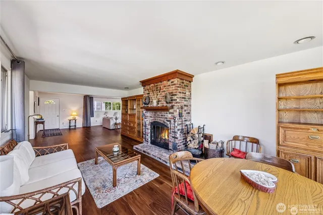 a living room with furniture fireplace and a large window