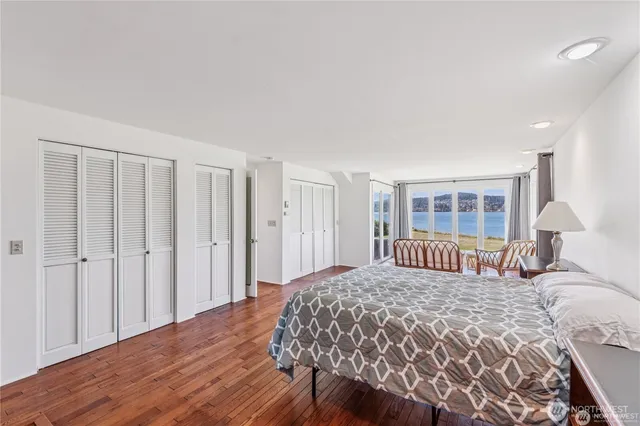 a bedroom with a large bed and a window