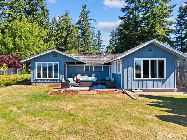 a front view of a house with swimming pool and porch
