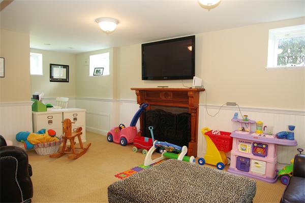 7 Westvale Road Milton, MA 02186 - Photo 12 of 14 a living room with furniture a flat screen tv and a fireplace