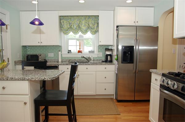 7 Westvale Road Milton, MA 02186 - Photo 4 of 14 a kitchen with granite countertop a sink stainless steel appliances and cabinets