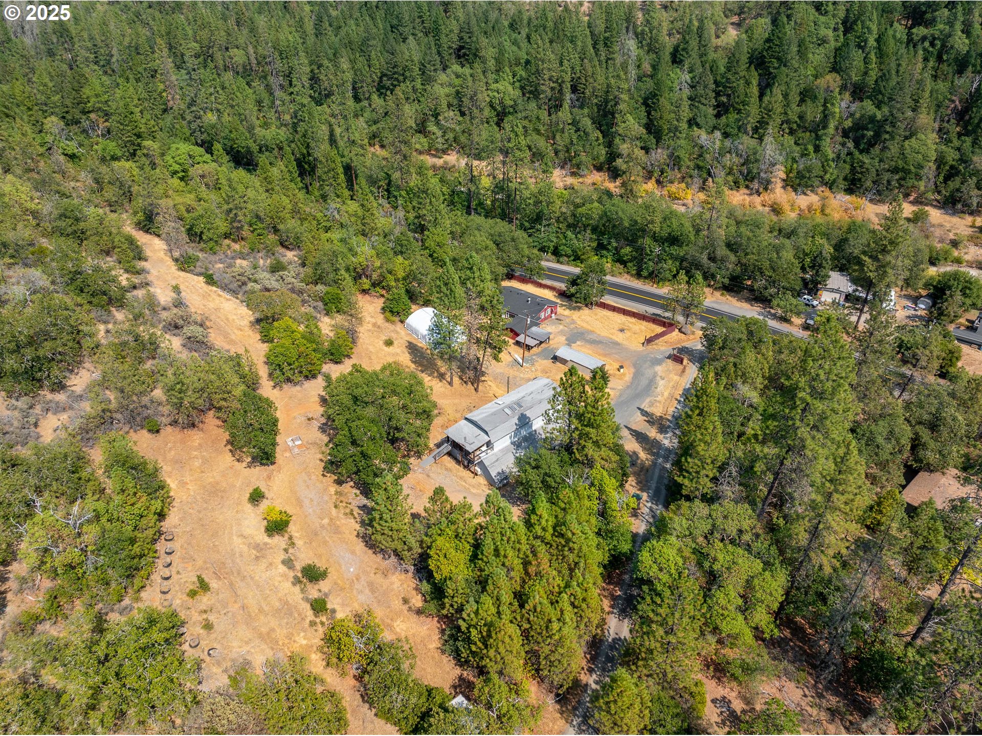 3461 West Evans Creek Road Rogue River, OR 97537 - Photo 33 of 40 a view of a yard with a tree