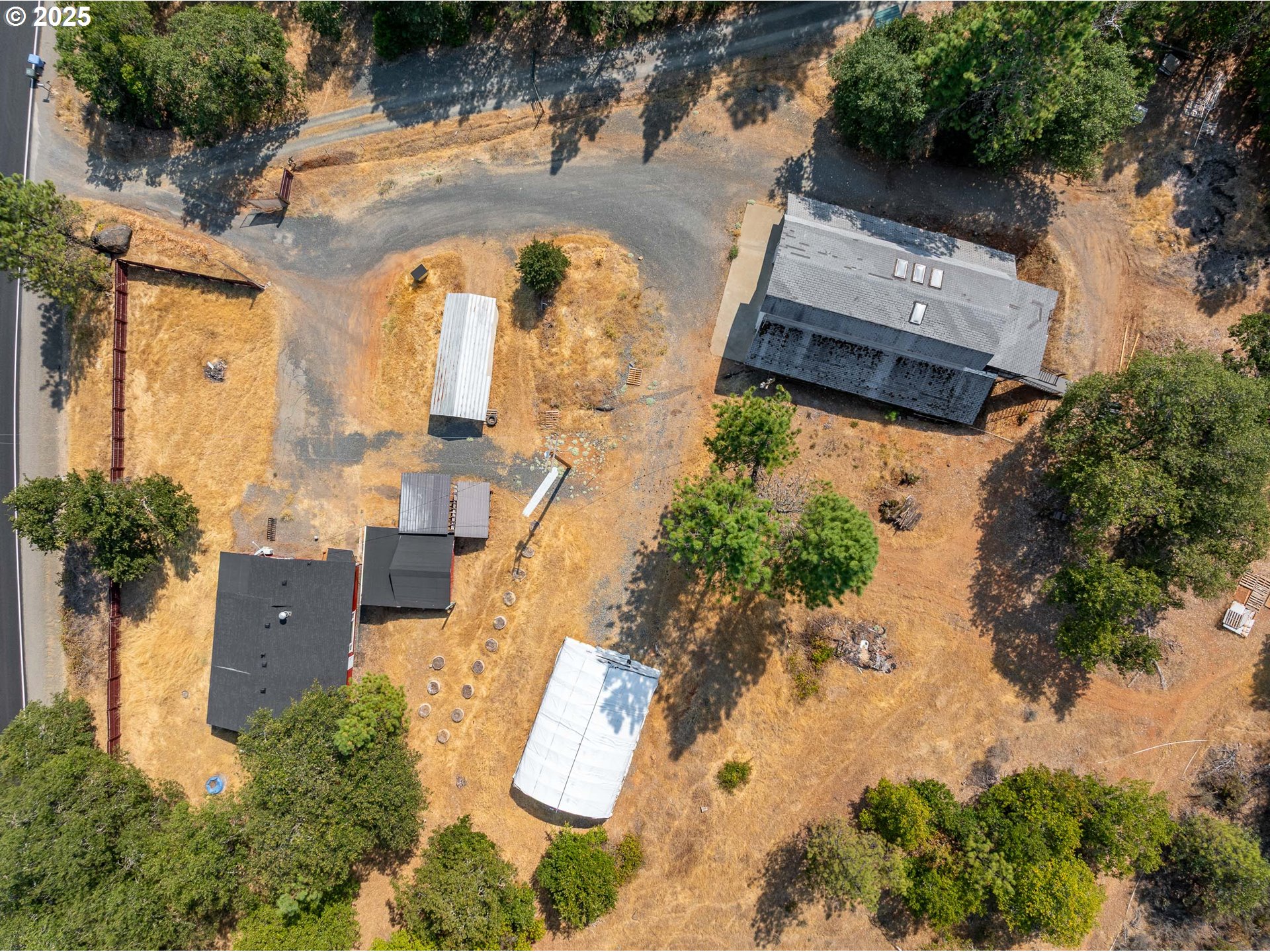 3461 West Evans Creek Road Rogue River, OR 97537 - Photo 34 of 40 an aerial view of a house with a yard and trees
