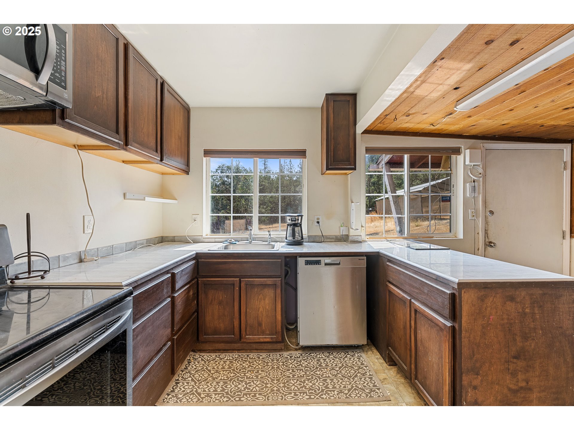 3461 West Evans Creek Road Rogue River, OR 97537 - Photo 6 of 40 a kitchen with a sink stove and cabinets