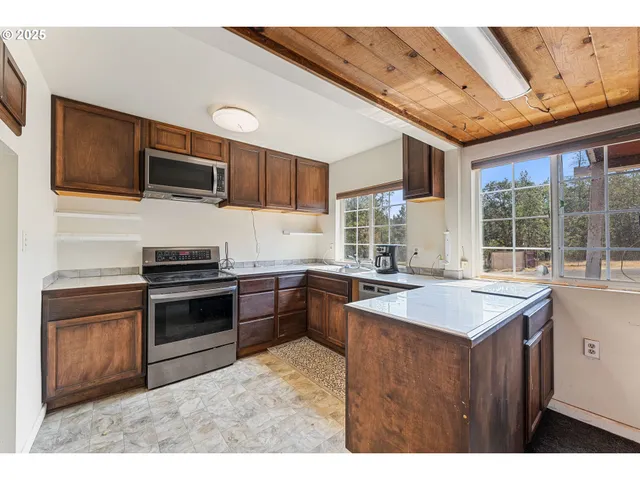 a kitchen with a stove sink and microwave