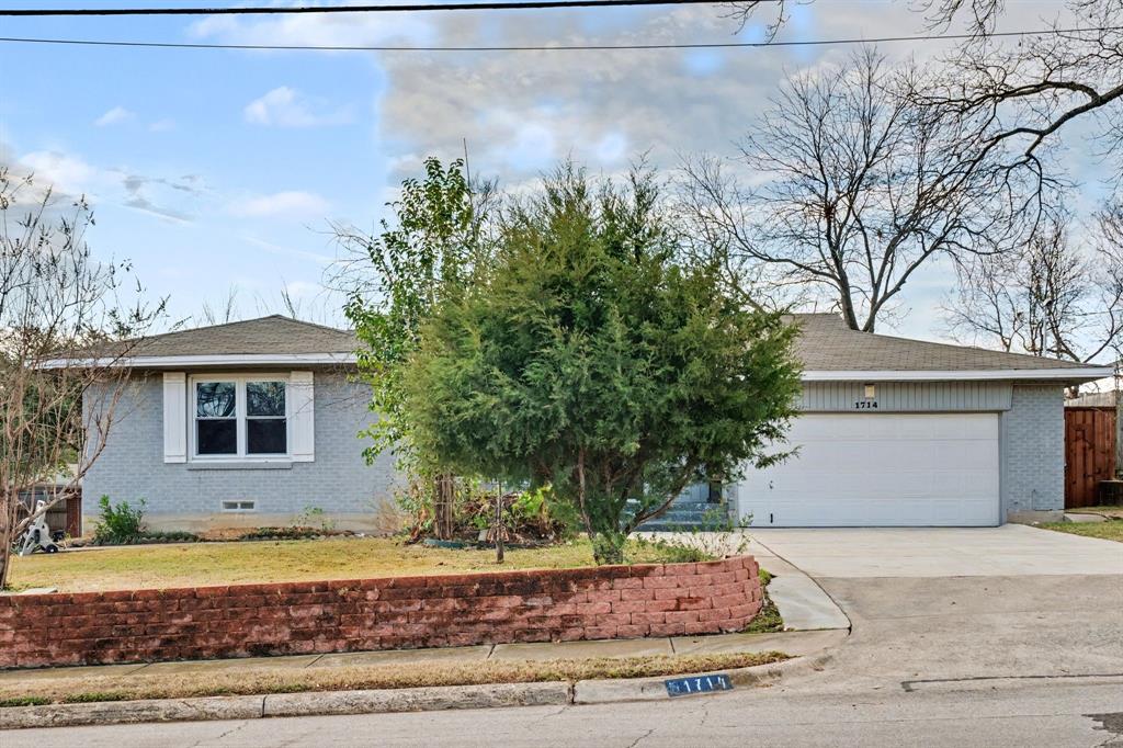 1714 East Union Bower Road Irving, TX 75061 - Photo 5 of 32 a front view of a house with a yard and a garage