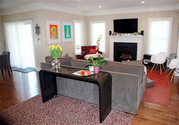 39 Thurston Lane Needham, MA 02492 - Photo 15 of 30 a living room with furniture a flat screen tv and a fireplace