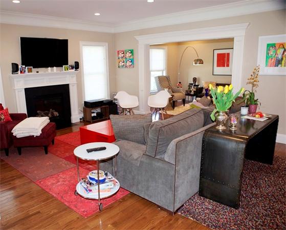 39 Thurston Lane Needham, MA 02492 - Photo 20 of 30 a living room with furniture a flat screen tv and a fireplace