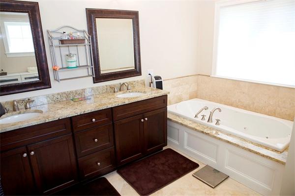 39 Thurston Lane Needham, MA 02492 - Photo 26 of 30 a bathroom with a tub sink and mirror