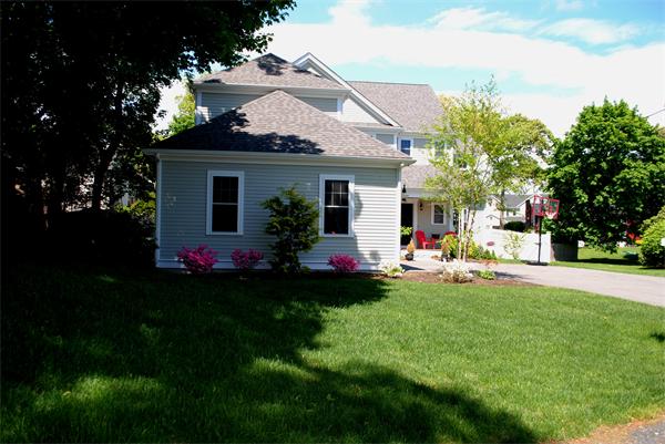 39 Thurston Lane Needham, MA 02492 - Photo 5 of 30 a front view of house with yard and outdoor seating