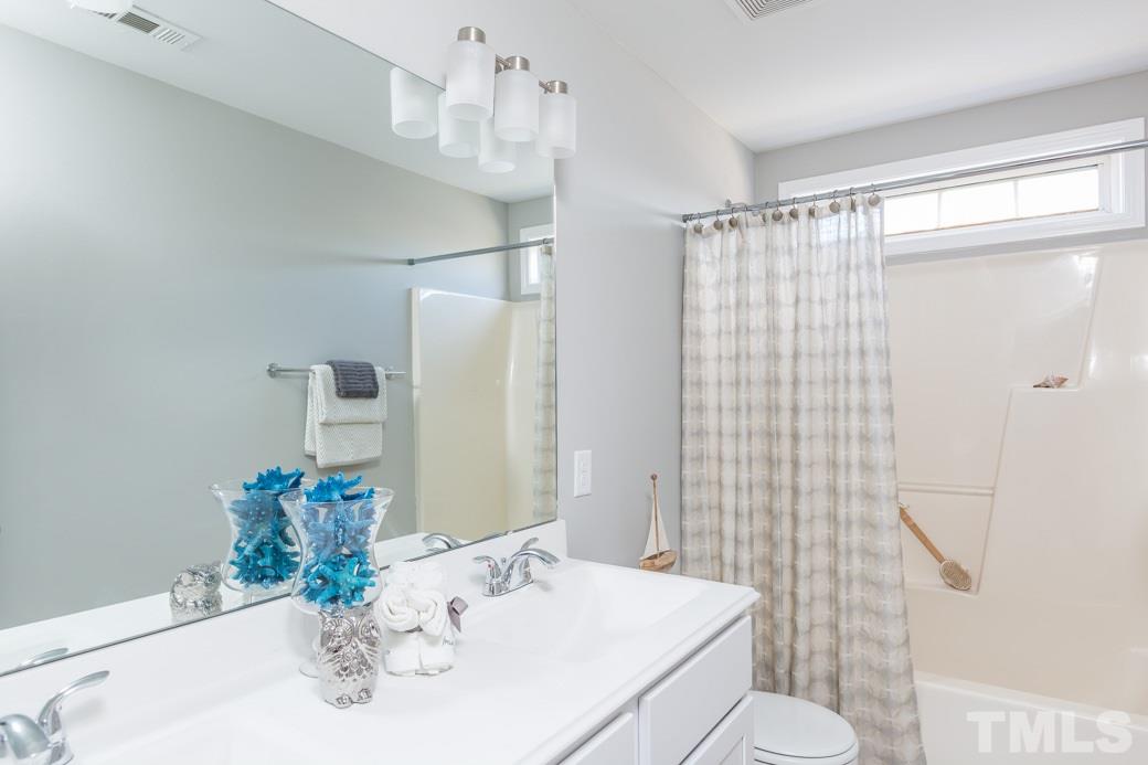232 Seastone Street Raleigh, NC 27603 - Photo 16 of 20 a bathroom with a sink toilet and shower