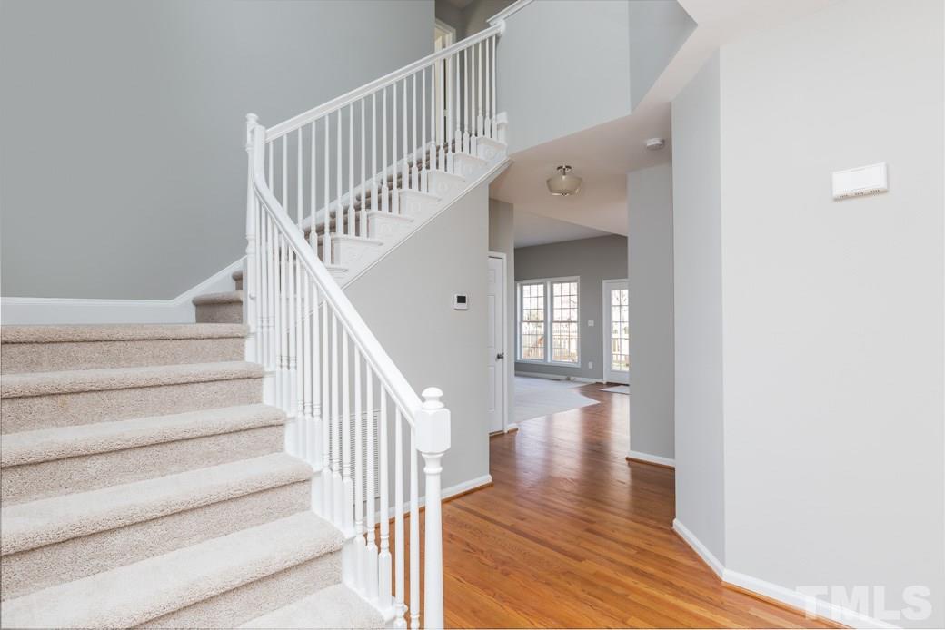 232 Seastone Street Raleigh, NC 27603 - Photo 3 of 20 a view of staircase with white walls and wooden floor