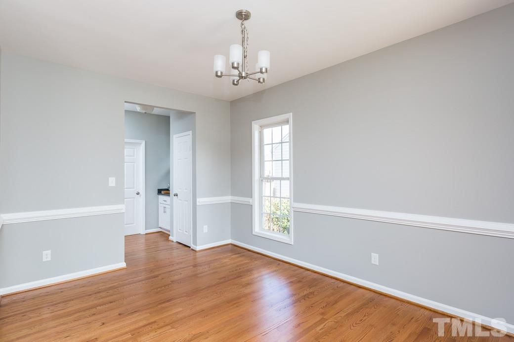 232 Seastone Street Raleigh, NC 27603 - Photo 5 of 20 wooden floor in an empty room with a window