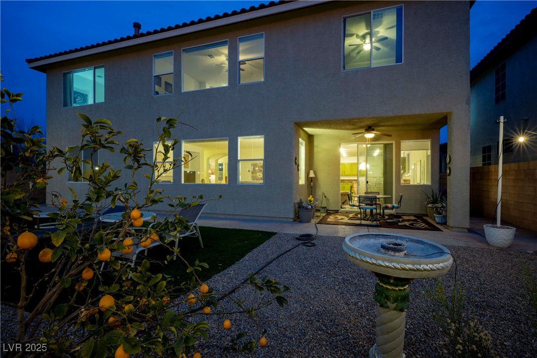 359 Hoskins Court Henderson, NV 89012 - Photo 81 of 85 Back of house at twilight with a ceiling fan, a pa