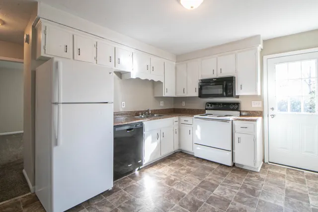 a white refrigerator freezer sitting in a kitchen
