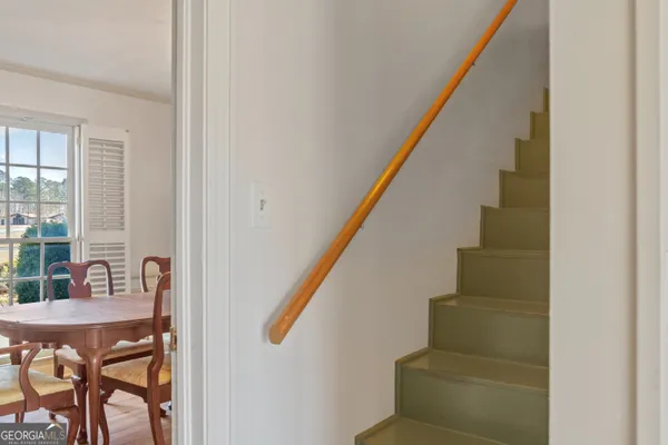 wooden floor fireplace and windows in an empty room
