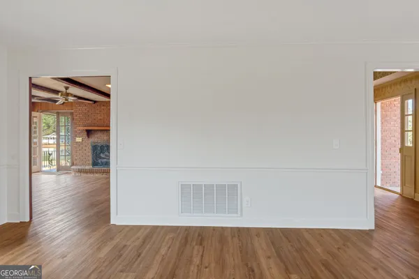 a view of entryway and hall with wooden floor