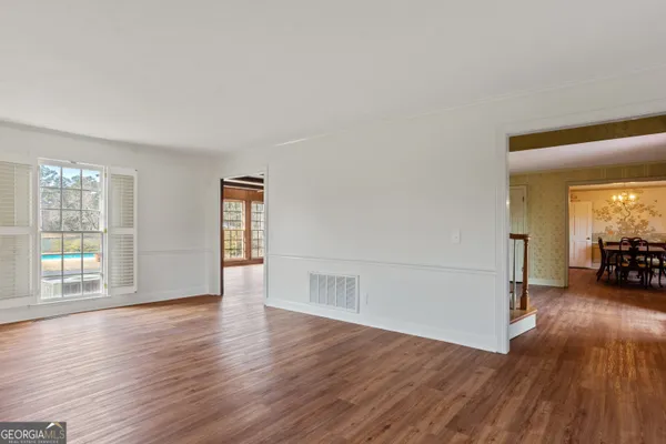 a view of a room with wooden floor and a window