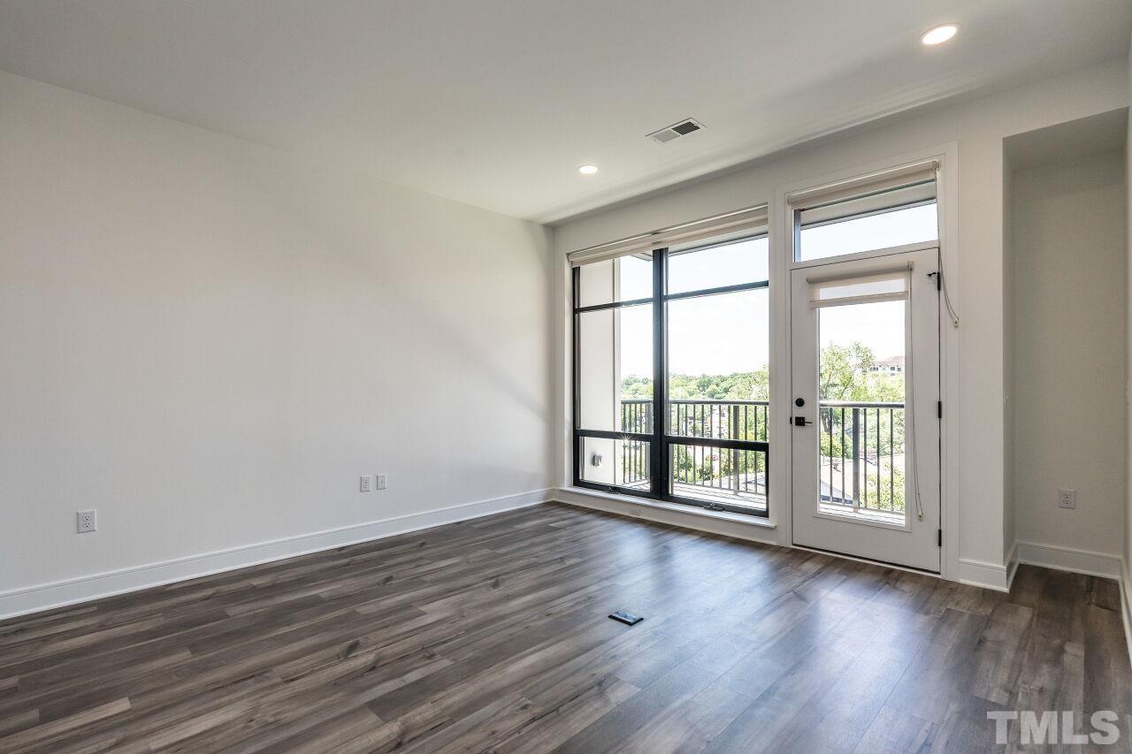 615 Daniels Street, Unit 318 Raleigh, NC 27605 - Photo 11 of 26 wooden floor in an empty room with a window