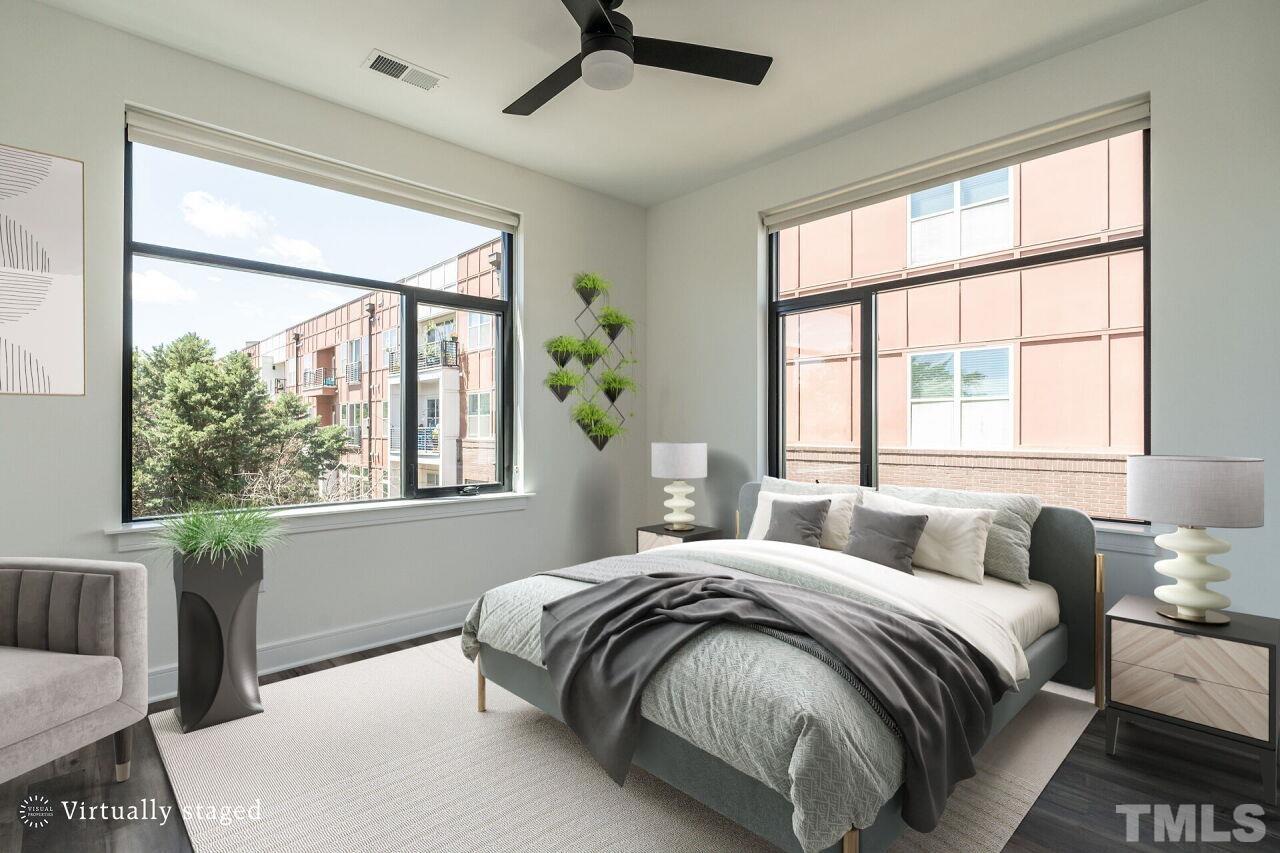 615 Daniels Street, Unit 318 Raleigh, NC 27605 - Photo 13 of 26 a bedroom with a large bed and a large window