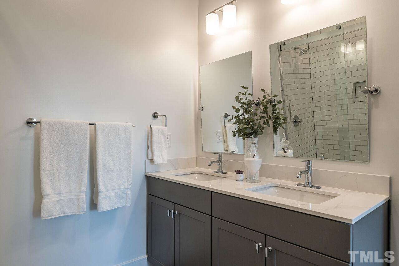615 Daniels Street, Unit 318 Raleigh, NC 27605 - Photo 17 of 26 a bathroom with a sink and a mirror
