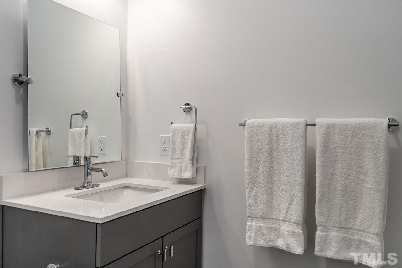 615 Daniels Street, Unit 318 Raleigh, NC 27605 - Photo 18 of 26 a bathroom with a sink and a mirror