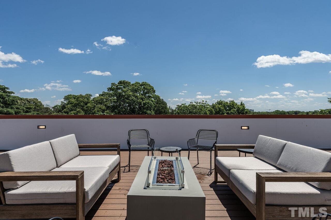 615 Daniels Street, Unit 318 Raleigh, NC 27605 - Photo 20 of 26 a view of a terrace with couches and a potted plant on a table