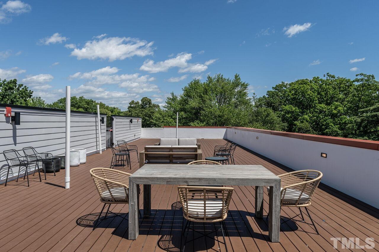 615 Daniels Street, Unit 318 Raleigh, NC 27605 - Photo 23 of 26 a roof deck with chairs and wooden floor