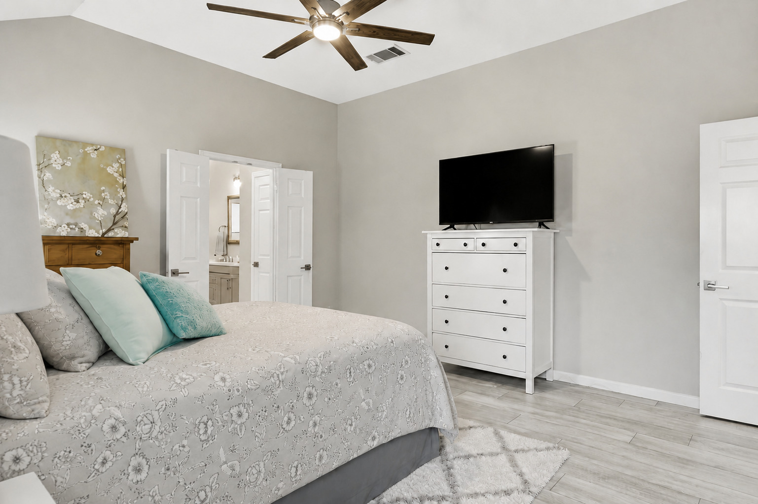1921 Rutherford Drive Leander, TX 78641 - Photo 18 of 29 High vaulted ceilings and wood-look flooring define this comfortable bedroom suite. Virtually Staged.