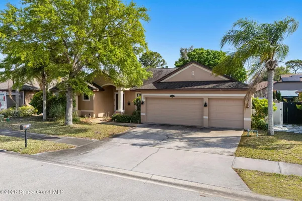 a house with palm tree in front of it