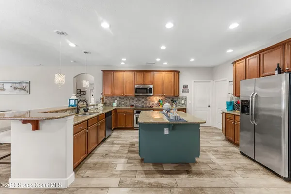 a kitchen with counter top space a sink appliances and cabinets